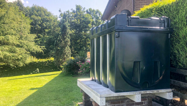 Heating Oil tank in a customers garden during sunny weather.