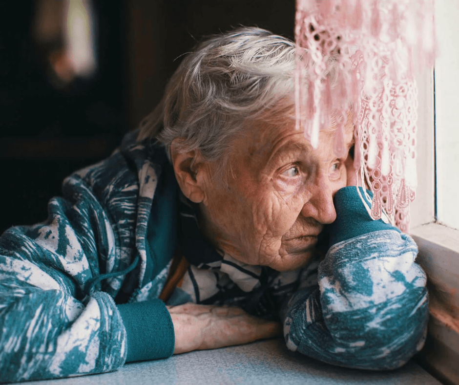 Lady looking out a window - reparing your home for Winter